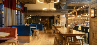 Alpine style tables and wood floors and walls to create authentic bier hall